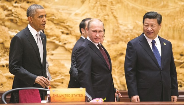 US President Barack Obama (left), arrives with his Chinese and Russian counterparts, Xi Jinping (right) and Vladimir Putin, at the the Asia Pacific Economic Cooperation (Apec) Summit plenary session at the International Convention Centre, at Yanqi Lake, in Huairou district of Beijing (file). Top world leaders will be meeting in Lima, Peru to chart a future for free trade at the annual Apec summit from tomorrow to Sunday.