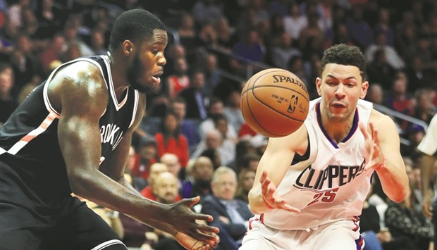 Anthony Bennett (left) of the Brooklyn Nets and Austin Rivers of Los Angeles Clippers battle for a loose ball during the second half of their NBA game at Staples Center in Los Angeles on Monday. (AFP)