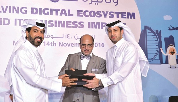 Al-Mansouri receives a token from Seetharaman during the conference.