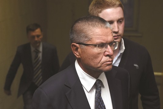 Ulyukayev, charged by the Investigative Committee with bribe-taking, is escorted before a hearing at the Basmanny district court in Moscow.