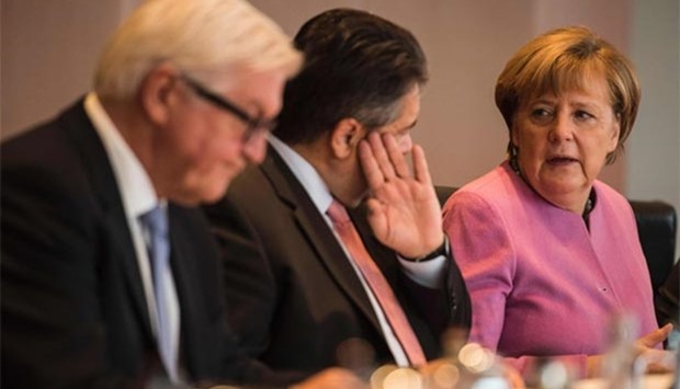 German Foreign Minister Frank-Walter Steinmeier (left), Vice Chancellor, Economy and Energy Minister Sigmar Gabriel (centre) and Chancellor Angela Merkel chat during a weekly meeting of the German cabinet in Berlin on Wednesday.