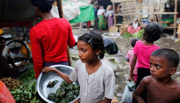 A girl sells food at the internally displaced personu2019s camp for Rohingya people outside Sittwe in the state of Rakhine, Myanmar
