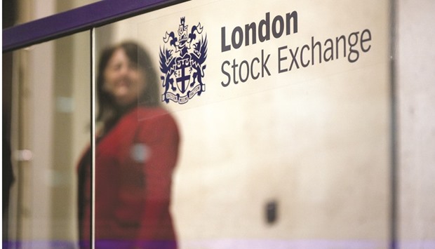 A visitor passes a sign inside the London Stock Exchange. The FTSE 100 closed down 0.8% to 6,740.94 points yesterday.