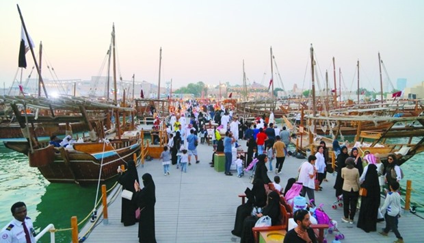 A view of the berthed dhows and visitors at Katara beach
