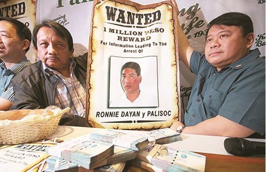 Volunteers Against Crime and Corruption founding chairman Dante Jimenez (left) and lawyer Ferdinand Topacio announce a 1mn pesos bounty for information leading to the arrest of Ronnie Palisoc-Dayan, former driver-bodyguard of Senator Leila de Lima.