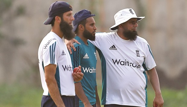 Englandu2019s spin consultant Saqlain Mushtaq (right) talks to bowlers Moeen Ali (left) and Adil Rashid during a practice session in Visakhapatnam, India, yesterday. (Reuters)