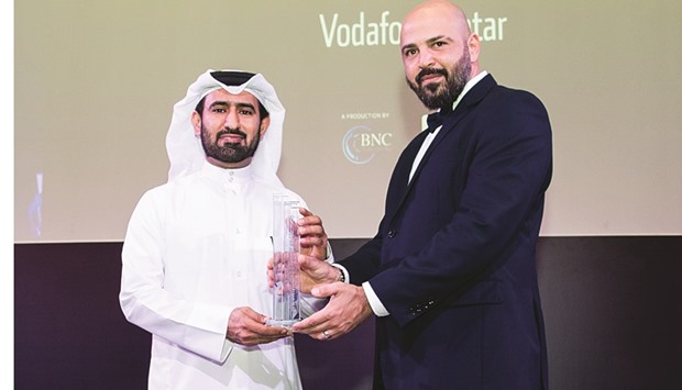 Vodafone Qatar director of External Affairs Mohamed al-Yami receiving the u2018Telecom Achiever of the Yearu2019 award.