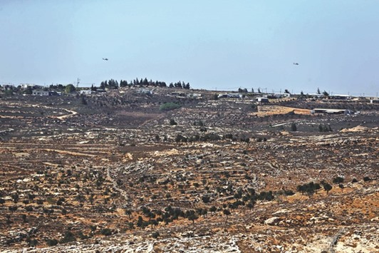 This file photo taken from the West Bank Christian village of Taybeh, shows the wildcat Jewish settlement of Amona. The Israeli parliament gave initial approval yesterday to a bill to legalise thousands of West Bank settler homes, a measure drawing international anger and posing the governmentu2019s biggest test since 2015 polls.