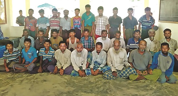 This undated handout photograph released by the Myanmar State Counselloru2019s Office show some 29 arrested suspects from the Muslim Rohingya minority at a Myanmar border police camp in Maungdaw. The detained men are suspects in recent attacks in Maungdaw, according to a report.