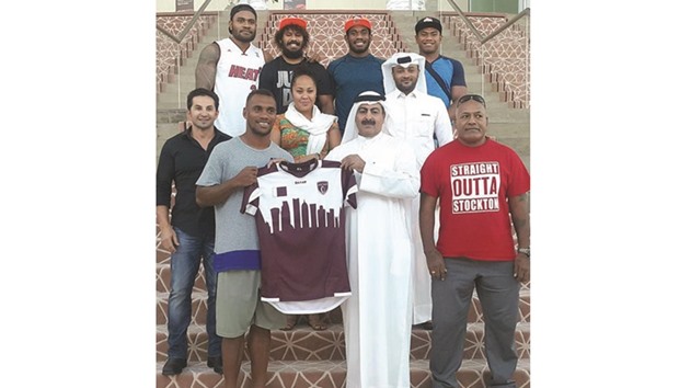 Qatar Rugby Federation president Yousef al-Kuwari presents Fiji captain Osea Kolinisau with a Qatar shirt in the presence of players and officials on Tuesday.