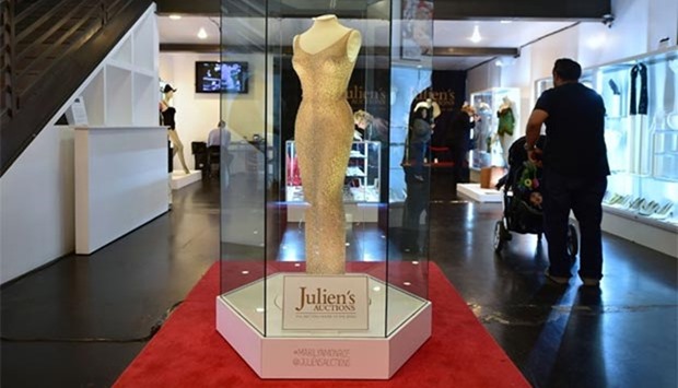 The dress worn by Marilyn Monroe in May 1962 is displayed in a glass enclosure at Julien's Auction House in Los Angeles, ahead of its auction on Thursday.