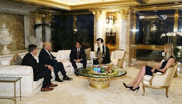 Japan's Prime Minister Shinzo Abe meeting with US President-elect Donald Trump in New York, as Trump's daughter Ivanka Trump looks on.
