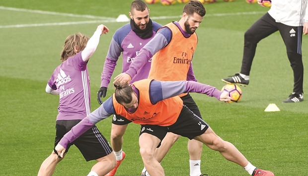 (From left) Real Madridu2019s Luka Modric, Gareth Bale, Karim Benzema and Nacho Fernandez take part in a training session at Real Madrid sport city in Madrid yesterday, on the eve of the Spanish league match against Atletico de Madrid. (AFP)