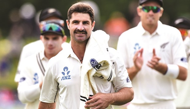 New Zealandu2019s Colin de Grandhomme (C) walks from the field at the end of the Pakistan innings with six wickets during day two of the first Test.