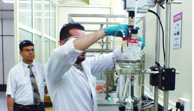 Dr Farid Benyahia and Karam ElAhmed working in the laboratory for the project