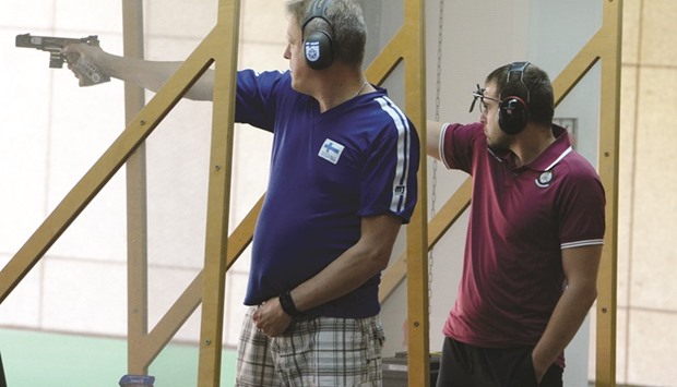 Qataru2019s Ivan Bidniak (right) takes aim during the 25m Rapid Fire Pistol team event in the 49th CISM World Military Shooting Championship at Losail Shooting Range yesterday. Qatar menu2019s team won silver in the event. PICTURES: Thajudheen