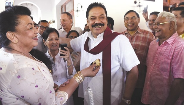 Sri Lankau2019s former president Mahinda Rajapakse, centre, celebrates his 71st birthday with family and friends at his official residence in Colombo yesterday. Rajapakse is expected to lead a breakaway faction of the ruling coalition of his successor Maithripala Sirisena, although he has publicly maintained silence about his future political plans.