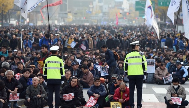 South Korean protesters sit on the street during an anti-government rally in central Seoul
