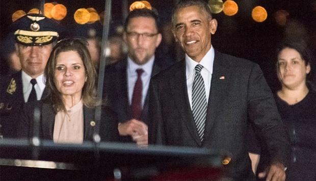 US President Barack Obama (2nd R) walking with Peru's Vice President Mercedes Araoz (2nd L) upon his arrival at Jorge Chavez International Airport in Lima