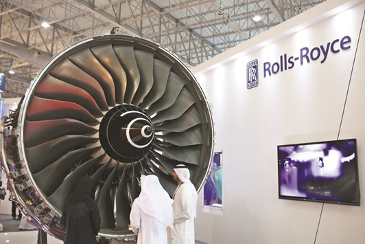 Visitors inspect a Trent 900 jet engine displayed at the Rolls-Royce exhibition stand at 14th Dubai Air Show in Dubai on November 9, 2015. Emirates last year ordered 217 Trent 900s u2013 sufficient to power the 50 four-engine A380s, plus spares u2013 after previously purchasing GP7000 powerplants from an alliance of General Electric Co and Pratt & Whitney for its first 90 superjumbos.