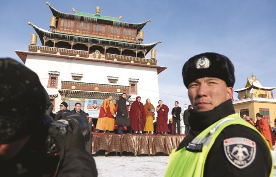 The Dalai Lama (centre) addresses people gathered at the Gandan Tegchinlen monastery in Ulan Bator.