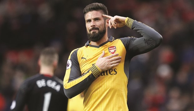 Arsenalu2019s Olivier Giroud celebrates after his teamu2019s Premier League game against Manchester at Old Trafford yesterday. It was the Frenchmanu2019s goal that gave Arsenal a draw.