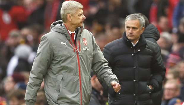 Arsenal manager Arsene Wenger (L) and Manchester United manager Jose Mourinho at the end of the match yesterday.