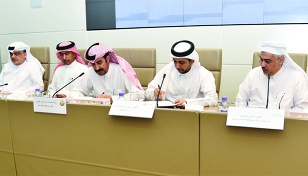 Al-Kaabi (third left) and Dr al-Derham (fourth left) sign the agreement to develop a STEM mobile lab