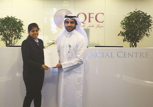 A Nimai official receiving the authorisation letter from a QFC official.