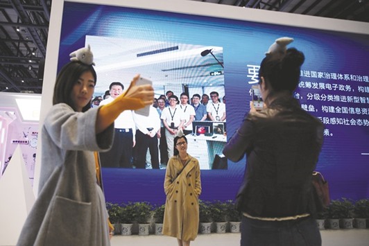 People pose for pictures during the third annual World Internet Conference in Wuzhen.