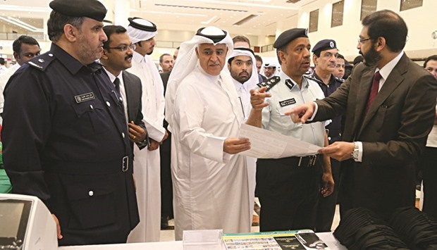 Brigadier al-Kharji, Brigadier (retired) al-Malki and other officials touring an exhibition held yesterday along with the event yesterday. PICTURE: Jayan Orma