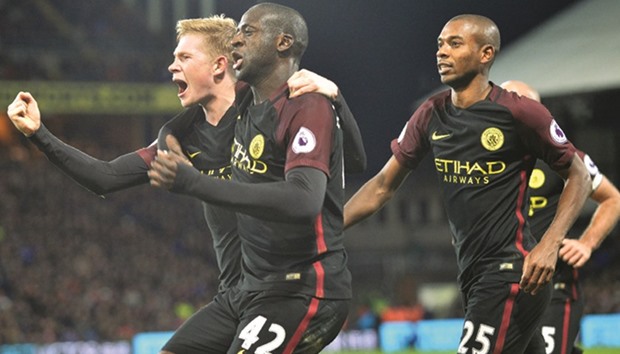 Manchester Cityu2019s Ivorian midfielder Yaya Toure (C) celebrates with Manchester Cityu2019s Belgian midfielder Kevin De Bruyne (L) and Manchester Cityu2019s Brazilian midfielder Fernandinho (R) after scoring their second goal during the English Premier League match against Crystal Palace at Selhurst Park in south London. (AFP)