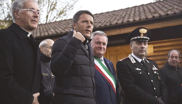 Renzi with Preci mayor Pietro Bellini (centre) arriving in Preci for an All Saints mass yesterday, two days after a 6.6-magnitude earthquake in central Italy.