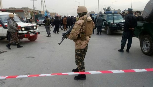 Afghan security forces keep watch in front of a mosque where an explosion happened in Kabul on Monday.