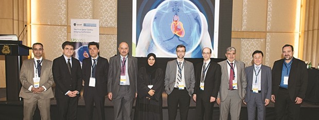 Dr Maryam al-Kuwari flanked by other speakers at the symposium poses for a group photo.