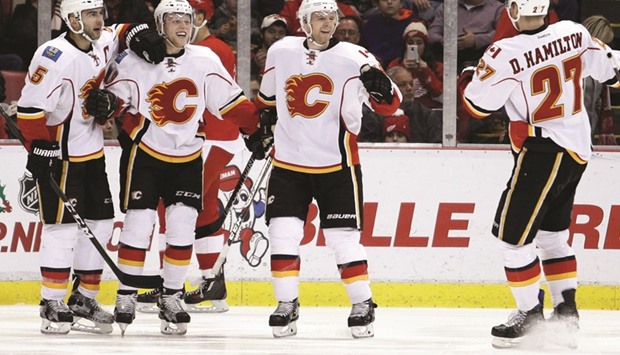 Calgary Flames Matt Stajan (second left) celebrates with defenseman Mark Giordano (left) centre Hunter Shinkaruk and defenseman Dougie Hamilton (right) after scoring a goal during the third period against the Detroit Red Wings at Joe Louis Arena. PICTURE: USA TODAY Sports