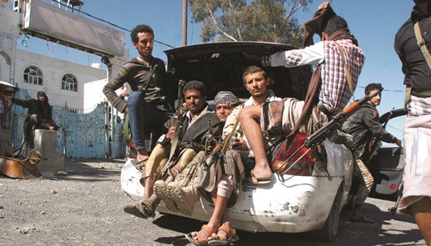 Pro-government fighters ride in the trunk of a car in the southwestern city of Taiz, Yemen, yesterday.