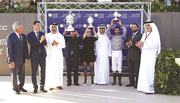 Qataru2019s ambassador to Morocco Abdullah bin Falah al-Dosari receives the trophy for Prix The President Of The UAE Cup after Al Shaqab Racingu2019s Nashmi won the 2100m race under jockey Faleh Bughenaim.