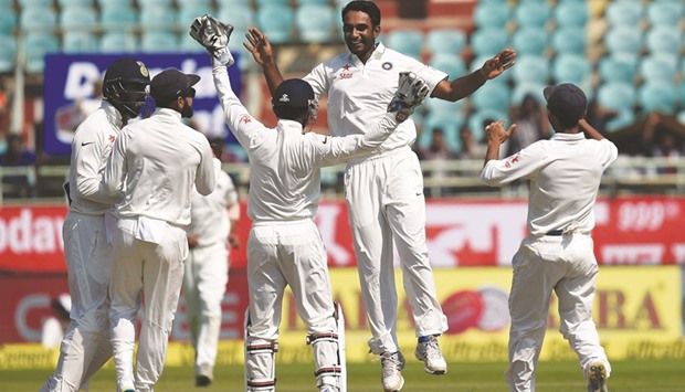 Indiau2019s Jayant Yadav (second from right) celebrates the wicket of Englandu2019s Ben Stokes with teammates on the last day of the second Test in Visakhapatnam, India, yesterday.  (AFP)