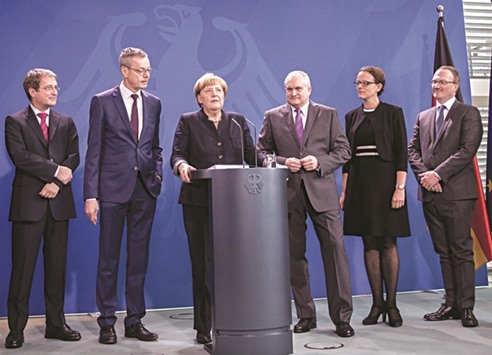 German Chancellor Angela Merkel (3rd left) addresses a press conference at the Chancellery in Berlin yesterday as she is handed over the annual report on the countryu2019s economic development by members of the German Council of Economic Experts (from left) Volker Wieland, Peter Bofinger, (Merkel), Christoph M Schmidt (the councilu2019s chairman), Isabel Schnabel and Lars P Feld. The experts also known as the five u201cwise menu201d predicted economic growth for the eurozone of 1.6% in 2016 and 1.4% in 2017.