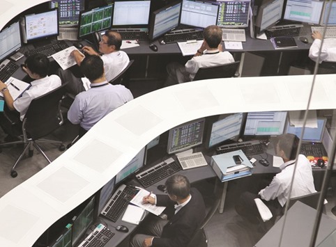 Employees work at the Tokyo Stock Exchange. The Nikkei 225 closed down 1.8% to 17,134.68 points yesterday.