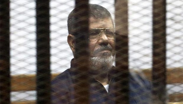 Mohamed Mursi is pictured behind bars at a court in this June 16, 2015 file photo.