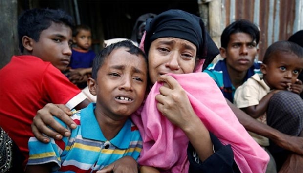A Rohingya Muslim woman and her son cry after being caught by Border Guard Bangladesh (BGB) while illegally crossing at a border check point in Coxu2019s Bazar on Monday.