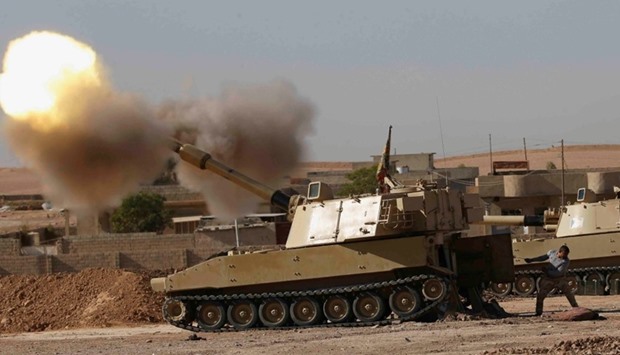 An Iraqi fighter fires artillery towards Islamic State militants, in Ali Rash southeast of Mosul, Iraq