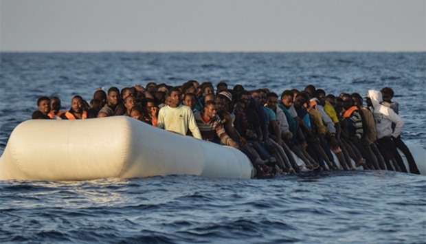 migrants and refugees on a rubber boat