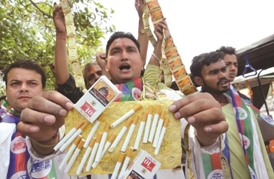 Tobacco growers stage protest against bigger pictorial warning on packs in New Delhi recently.