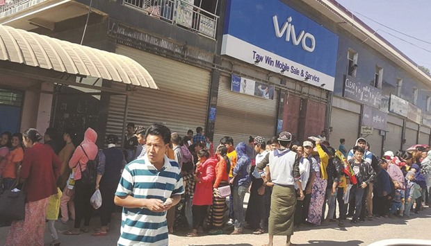 A long queue of Myanmar residents wait at the border immigration crossing in Muse, in Shan State, to cross into Chinau2019s Yunnan province yesterday as clashes between the military and ethnic insurgents increased.