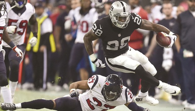 Oakland Raiders Latavius Murray (No 28) eldues the tackle of Houston Texans Quintin Demps during the 2016 NFL week 11 regular season game at the Azteca Stadium in Mexico City. (AFP)