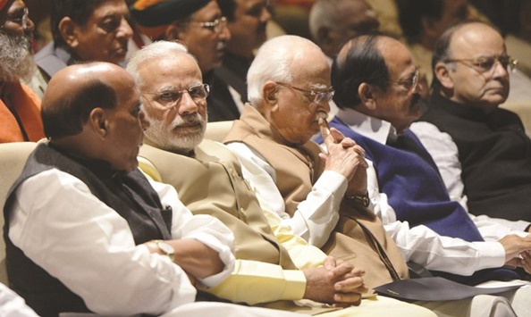 Prime Minister Narendra Modi speaks with Home Minister Rajnath Singh, as BJP veteran L K Advani, Information and Broadcasting Minister M Venkaiah Naidu and Finance Minister Arun Jaitley look on during a BJP Parliamentary Party meeting in New Delhi yesterday.