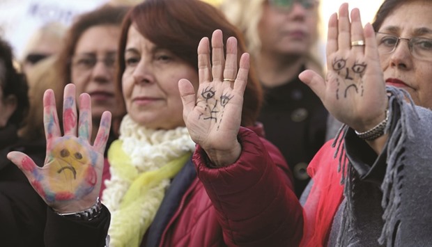 Protesters show their painted hands during a demonstration yesterday against the bill that could overturn menu2019s convictions for child sex assault in front of the Turkish Parliament in Ankara.